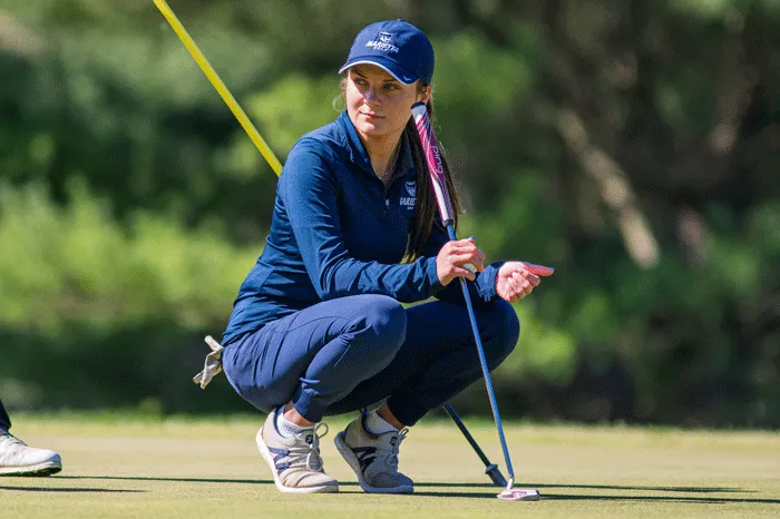 Helena Immel crouched down on a golf course