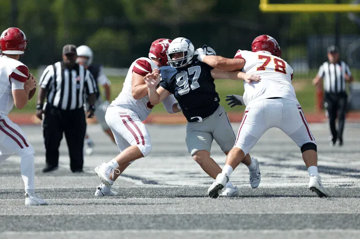 MC defensive lineman fighting off blocks
