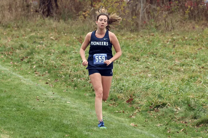 Competitor running alone in cross country race