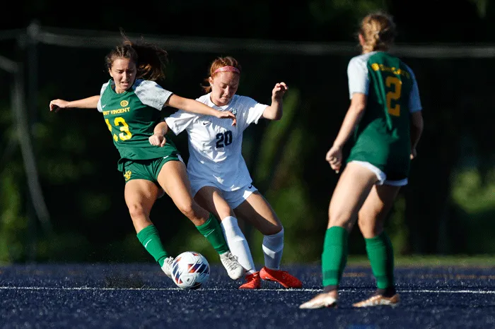 Soccer players battling for the ball