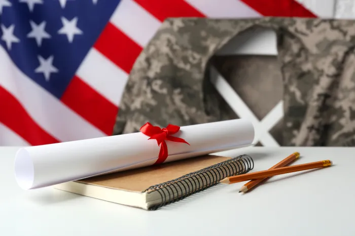 Military education photo of diploma and military uniform with an American flag background