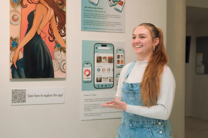 Female graphic design student presents art project