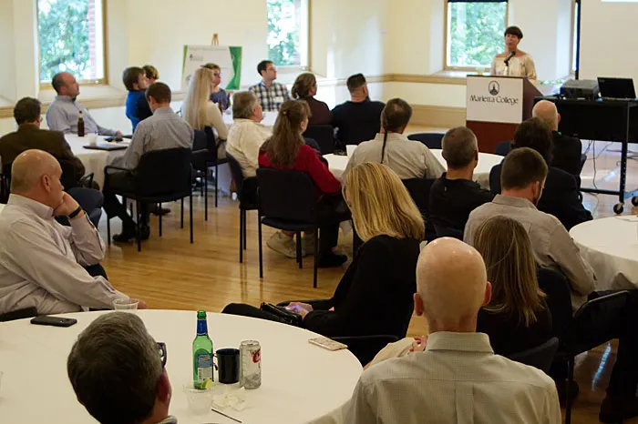 People listen to speaker at a conference