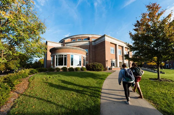 Two students walking toward Legacy Library