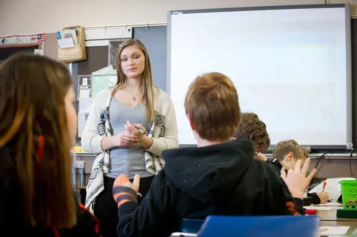 Student teacher in classroom with junior high children