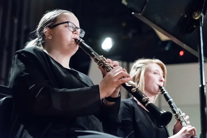 Two females playing clarinets