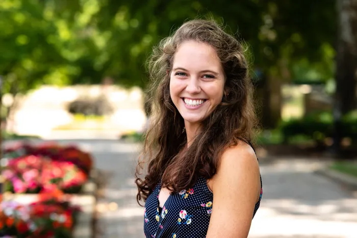 Rebecca Guhde smiling while standing on The Christy Mall