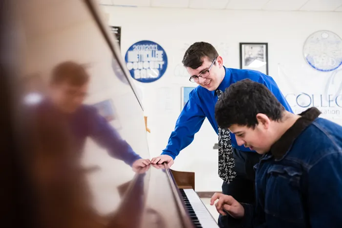 Students playing a piano