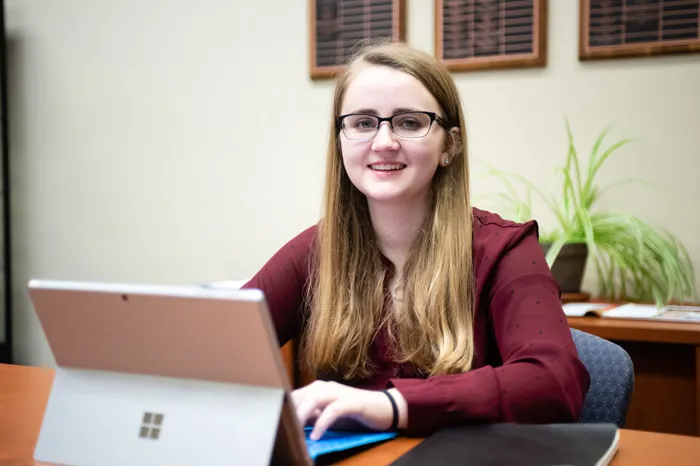 Student Ashley Klopfenstein sitting behind a computer