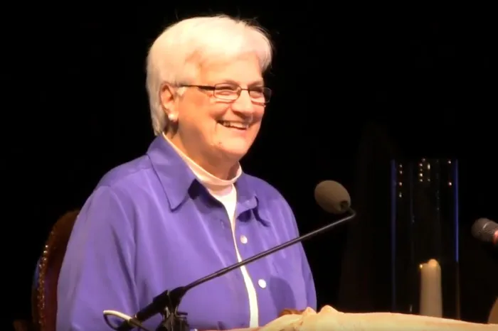 Mary Luti speaking from a podium