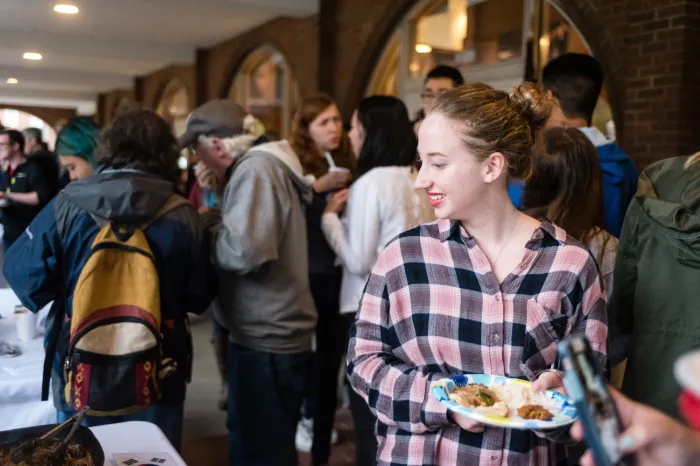 Female student carrying a plate of food during the Multicultural Festival