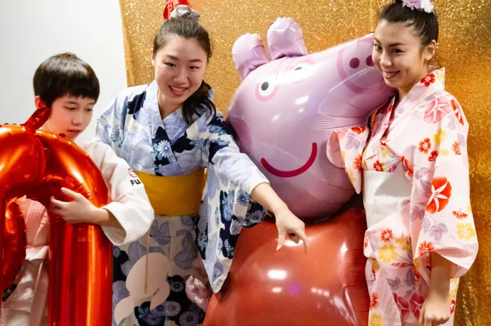 Two women and a boy dressed in traditional Chinese attire