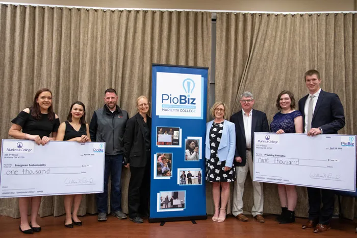 PioBiz winners posing with checks and the judges