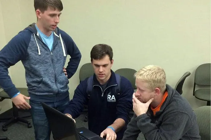 Marietta students working out a problem on a laptop computer