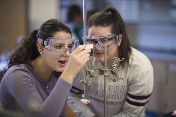 Two female students conducting a science experiment