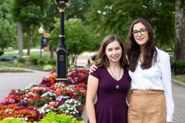 Two female students standing next to each other on The Christy Mall