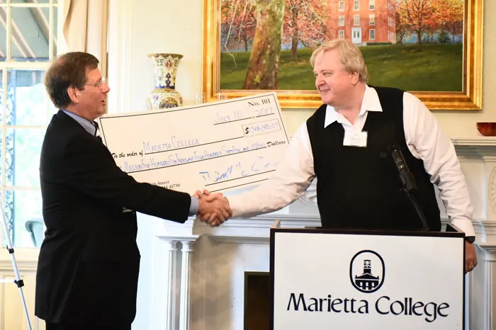President Ruud shakes the hand of David Goldenberg during a check presentation