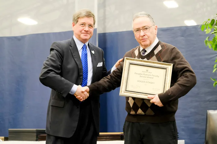 President Ruud congratulating Dr. Roger Pitasky