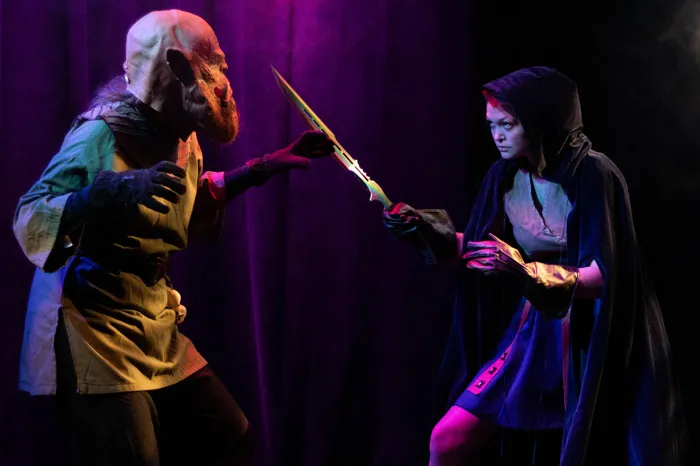 Actress fighting a monster in a play