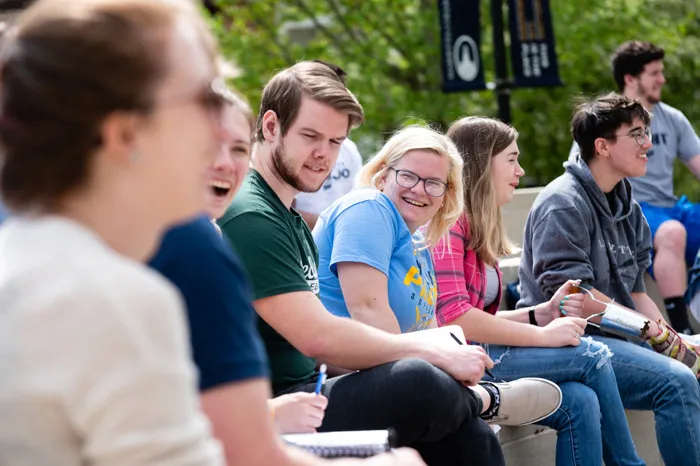 Students sitting outside on campus