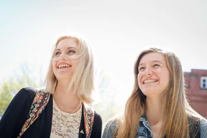 Two students smiling