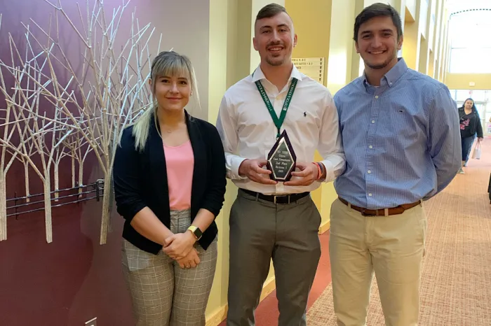 Marietta students holding their award