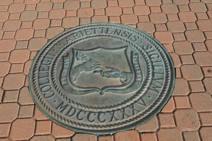 The Marietta College Seal in the brick ground outside of the Legacy Library
