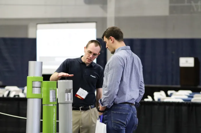 Worker explaining something to a student