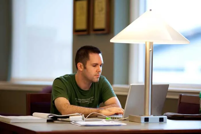 Male student studying in library