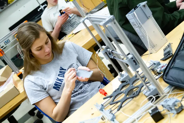 Female student working on a 3D printer