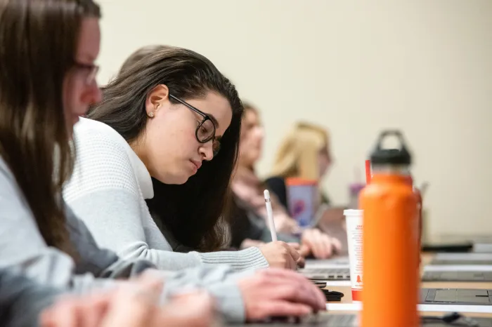 Female student taking notes in class