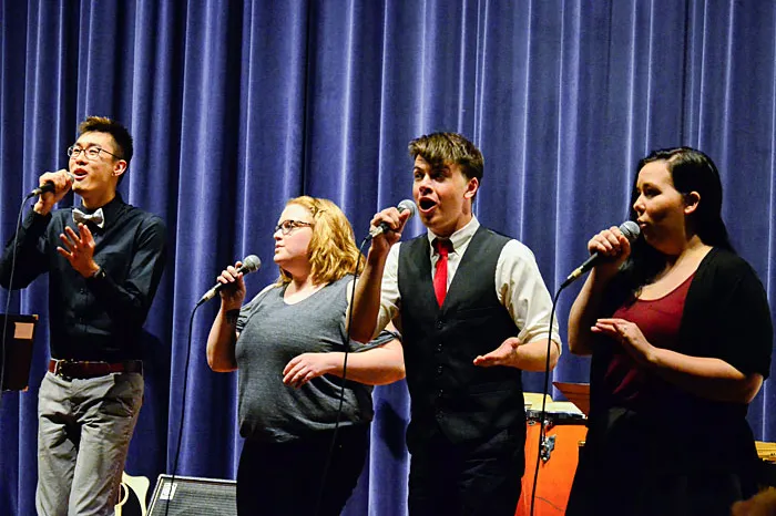 four students singing