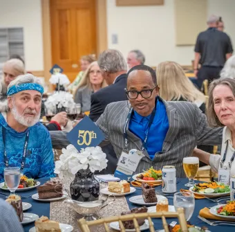 Two alumni and one alumna pose during the 2025 Golden Reunion Dinner
