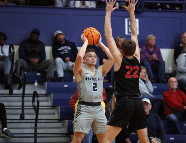 Basketball player looking to pass while being pressured