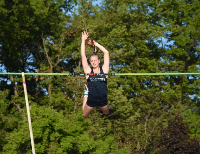 Pole vaulter clearing the bar