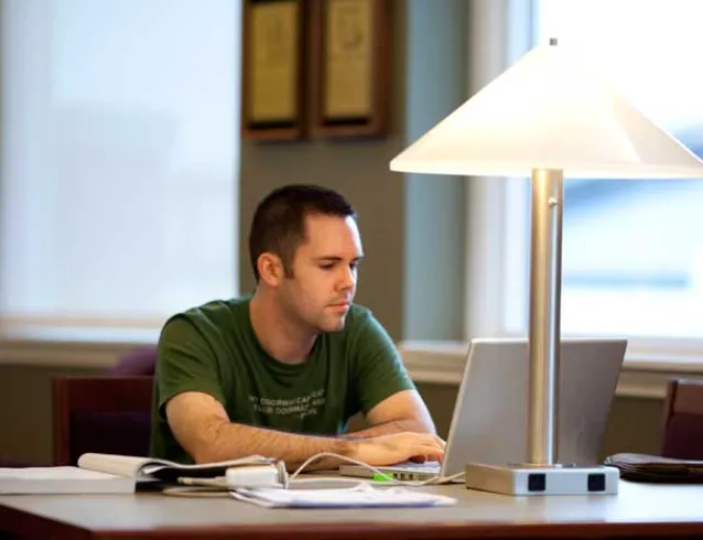 Male student studying in library