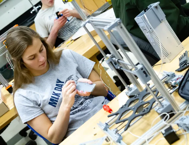 Female student working on a 3D printer