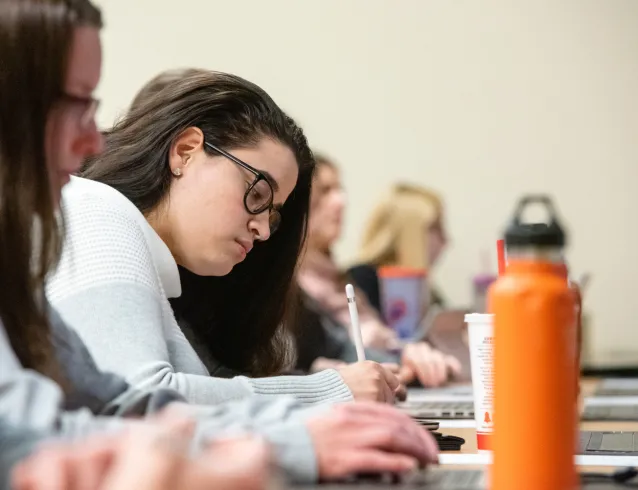 Female student taking notes in class