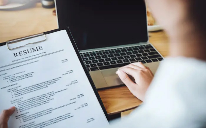 Typing on laptop to create a resume