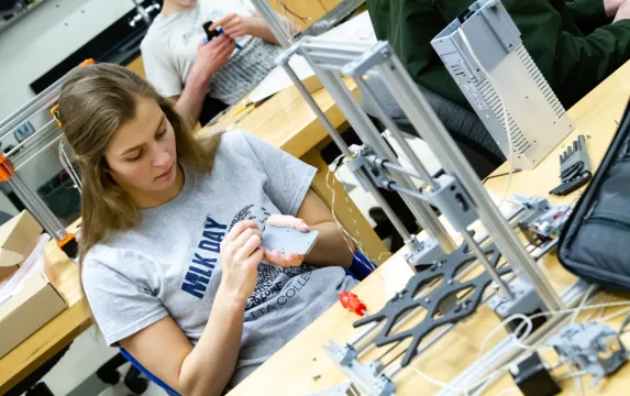 Female student working on a 3D printer