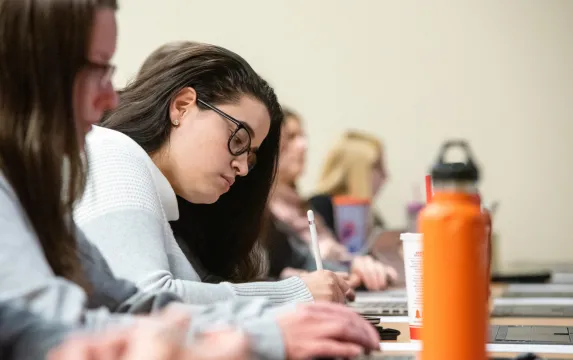 Female student taking notes in class