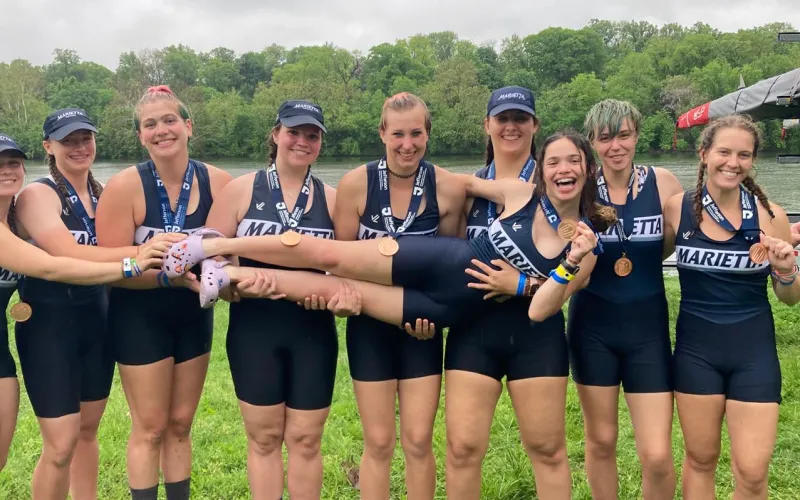 Marietta College Women's Rowing team poses with bronze medal