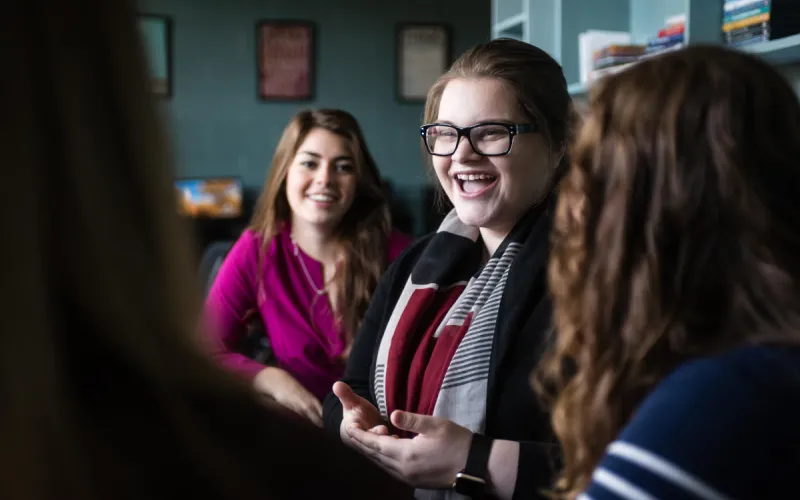 Marietta College student laughing in the Communication Resource Center room