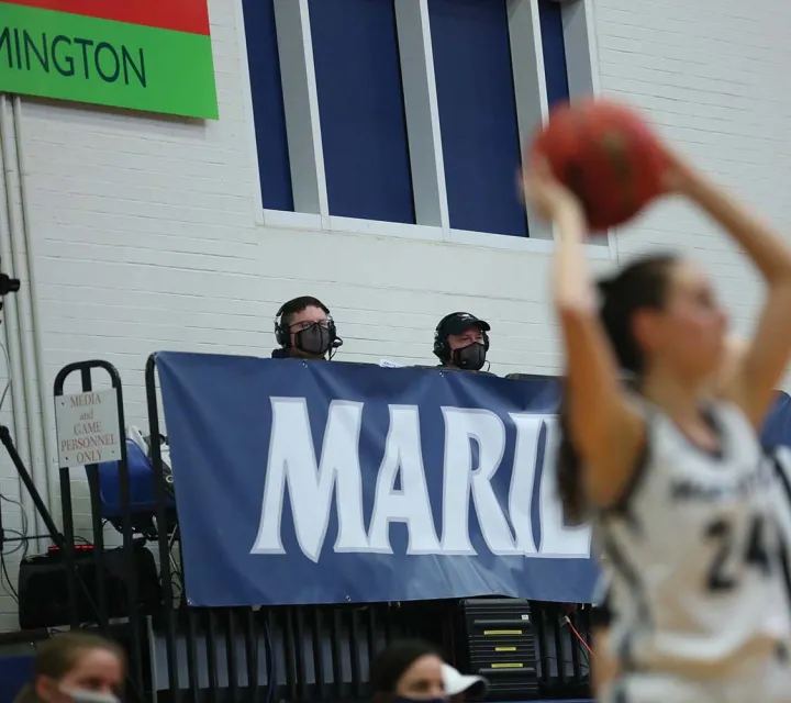 Two streamers in stands at a basketball game