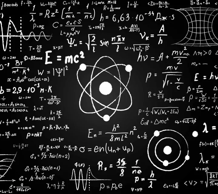 image of physics equations on a blackboard