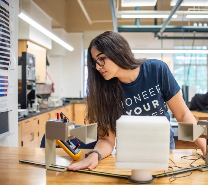 Marietta College student Lilly Daneshmand at an experiment in a science classroom