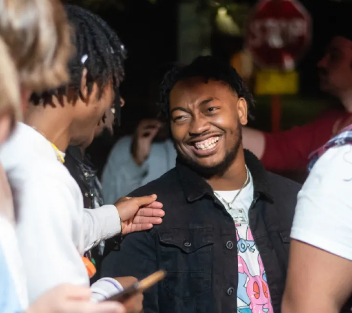 Students joking and smiling outside at night