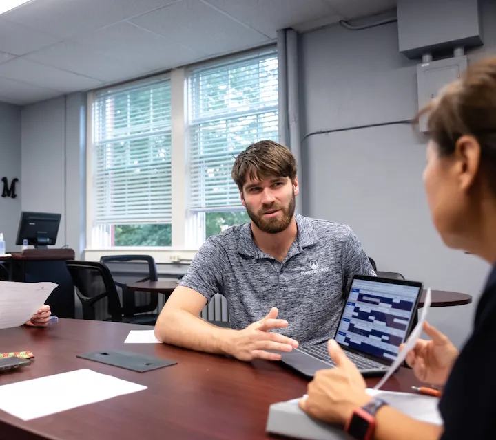 A Communication Studies student meets with a professor