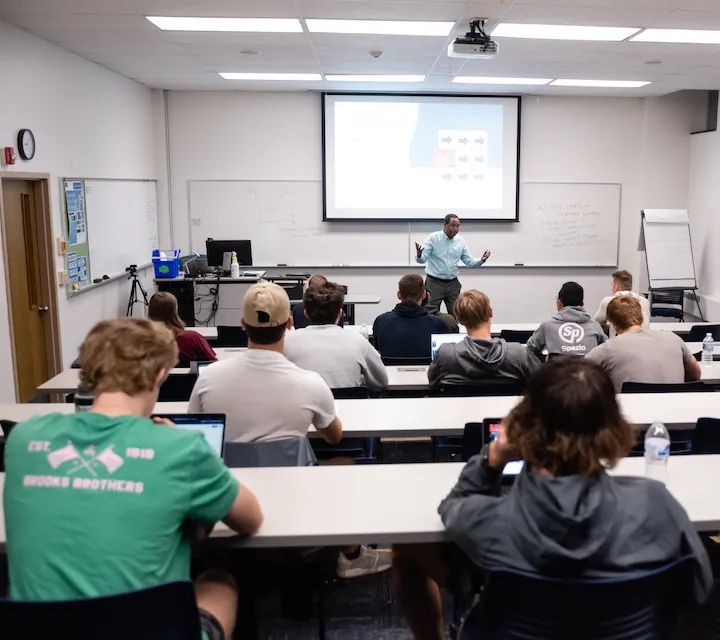 Professor Bizuayehu Bedane teaching economics majors during and econ class