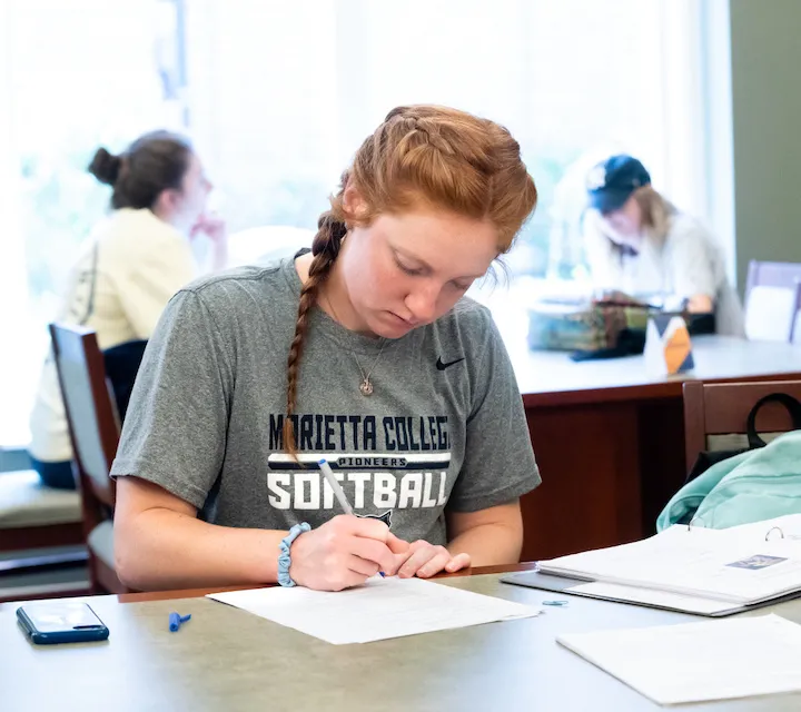 An english major studies in the Legacy Library at Marietta College